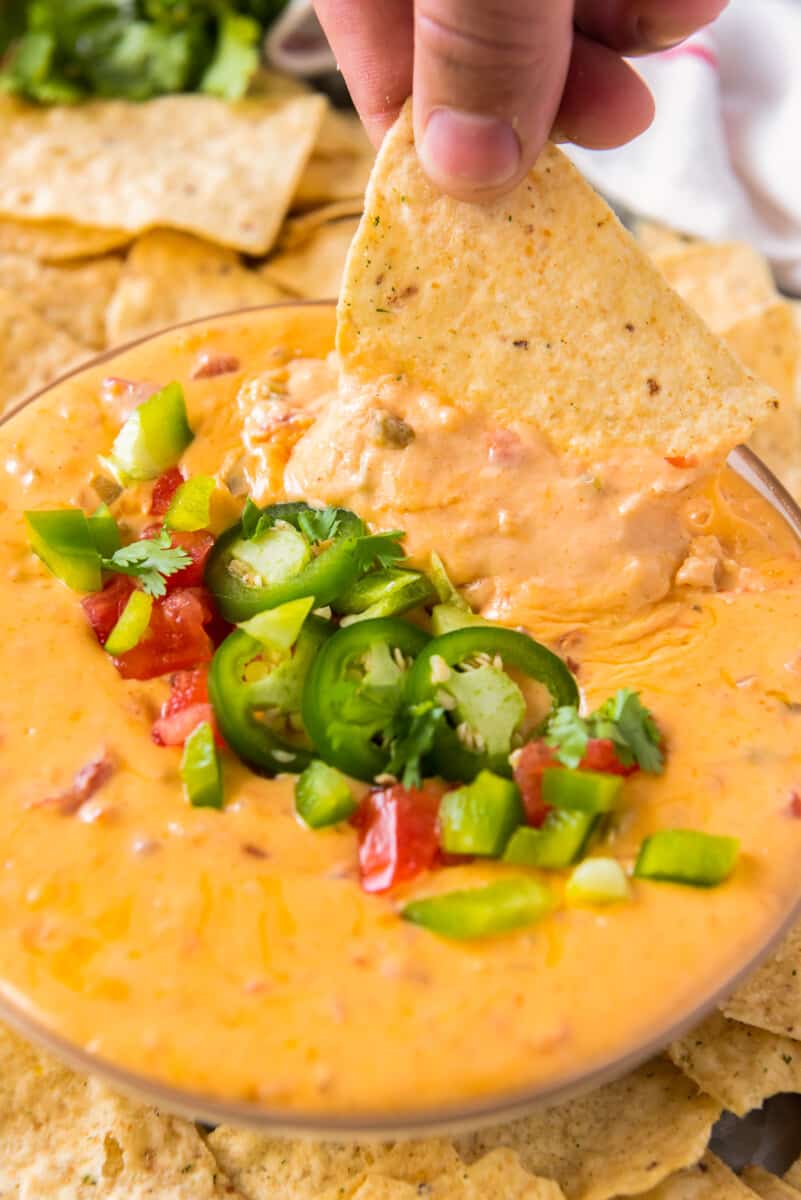 chip dipping into instant pot queso