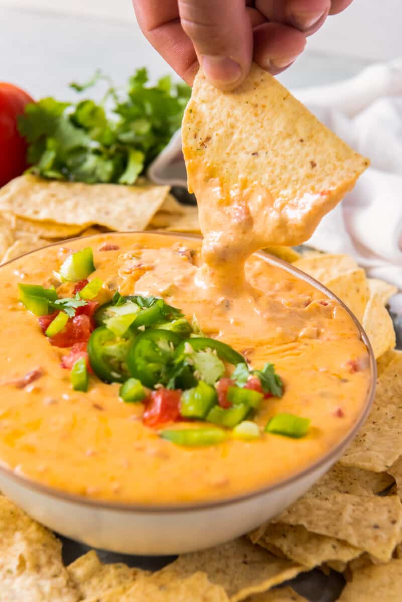 chip dipping into instant pot queso