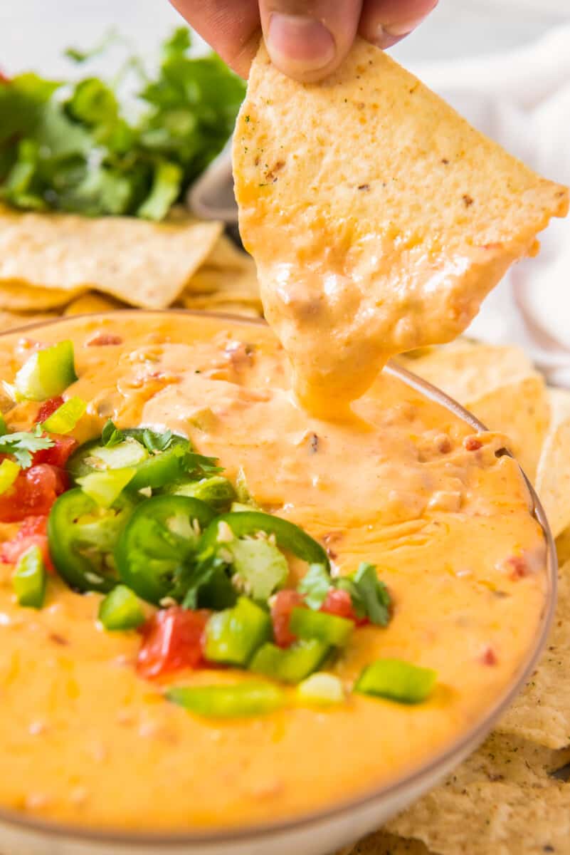 chip dipping into instant pot queso