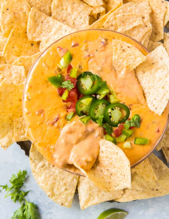 bowl of instant pot queso with chips and jalapenos