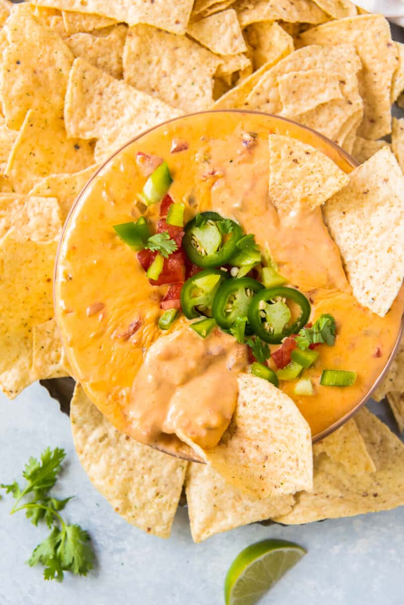 bowl of instant pot queso with chips and jalapenos