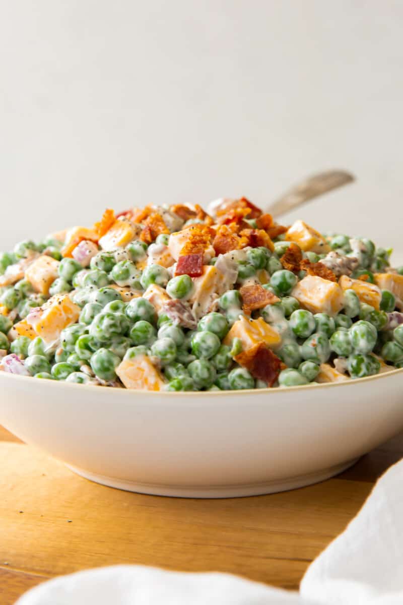 bowl of pea salad with cheese and bacon