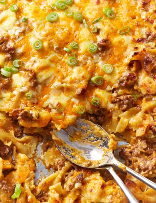 sloppy joe casserole in a baking pan with spoons.