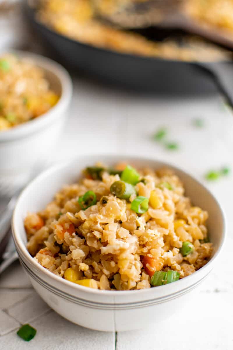 cauliflower fried rice in a white bowl.