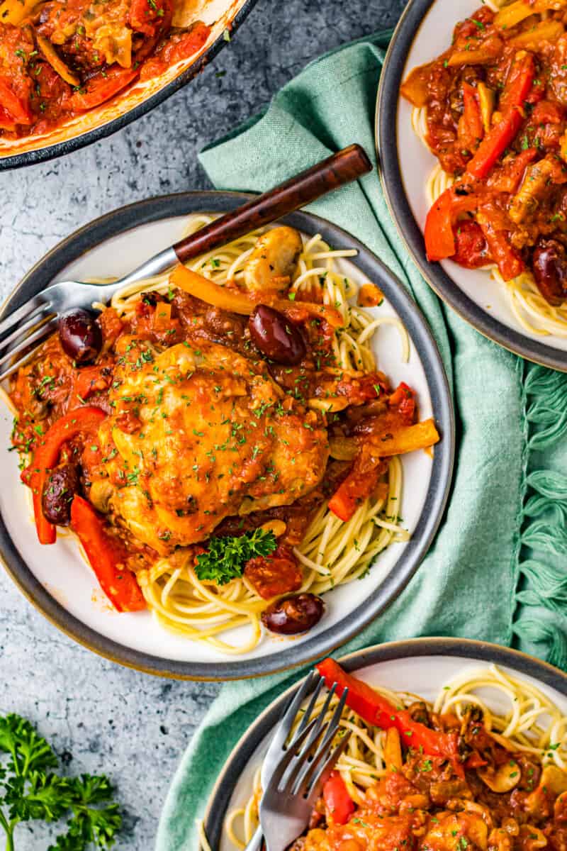 overhead three plates of pasta and chicken cacciatore