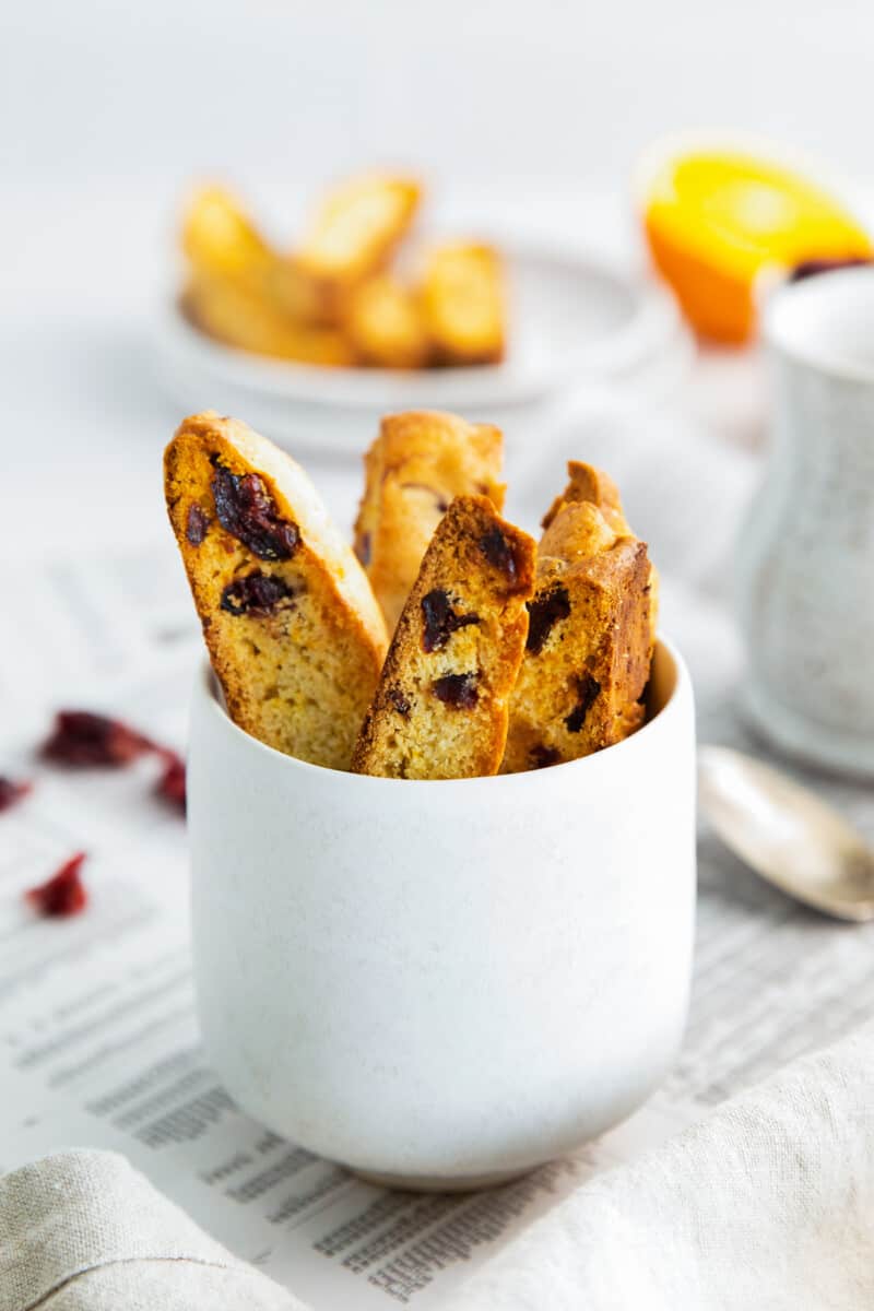 coffee cup filled with cranberry orange biscotti
