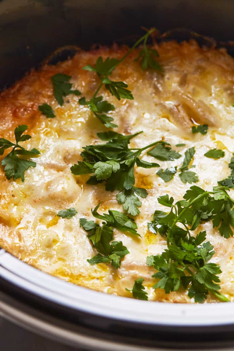 up close crockpot cheesy potatoes in slow cooker