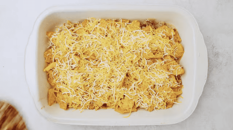 Cheesy Doritos nachos casserole in a white baking dish.