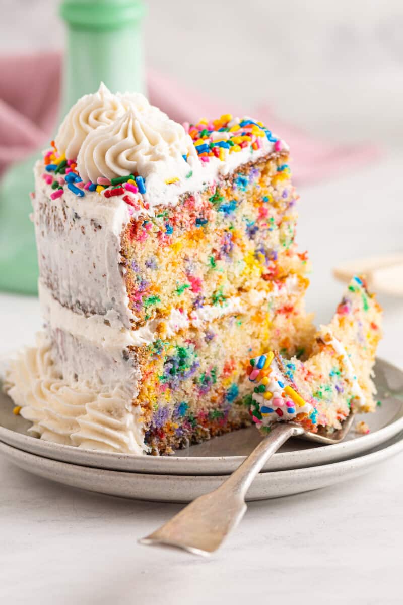 frosted funfetti cake on green cake stand