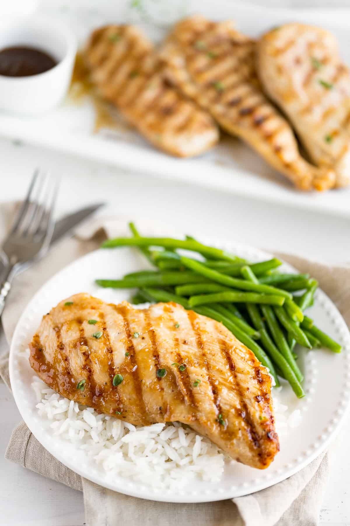 Grilled teriyaki chicken with green beans and white rice.