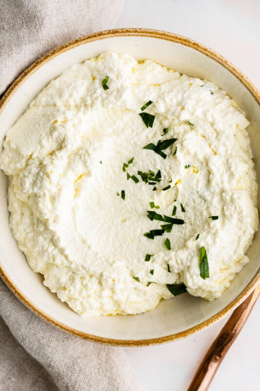 overhead up close homemade ricotta cheese in bowl