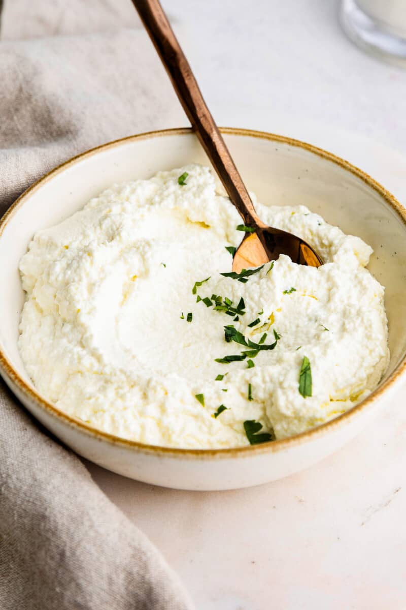 spoon in ricotta in bowl