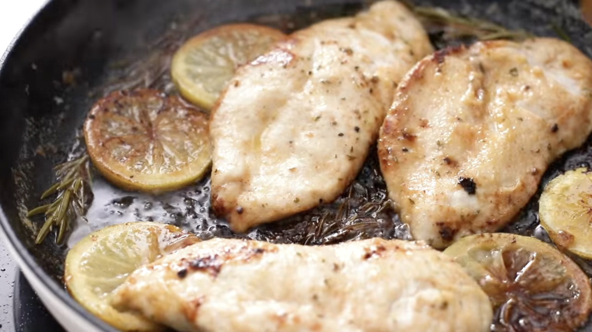 close up of lemon chicken in a cast iron skillet.