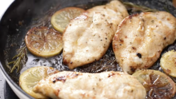 close up of lemon chicken in a cast iron skillet.