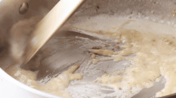 stirring a deglazed roux with a wooden spoon.