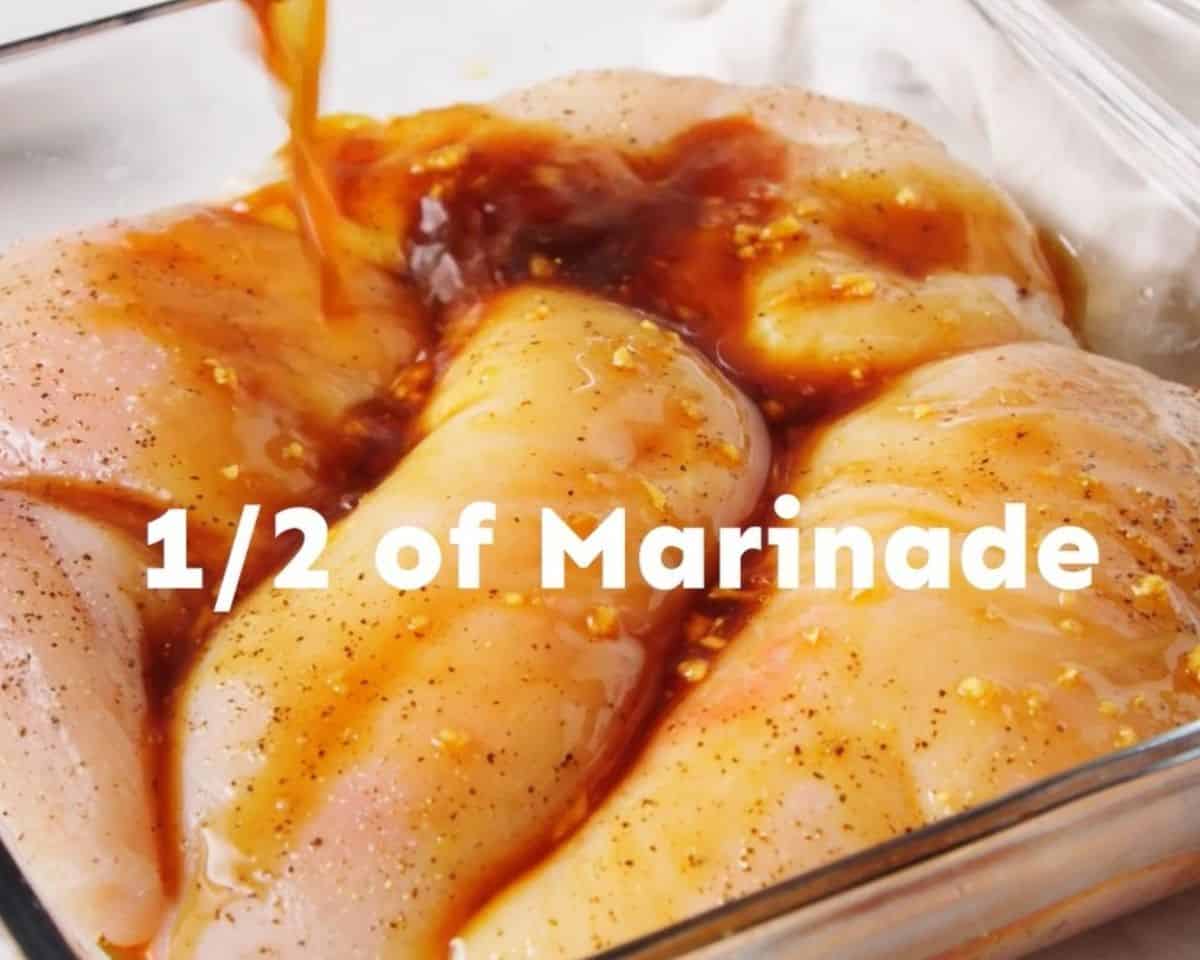 Seasoned chicken being covered in marinade.