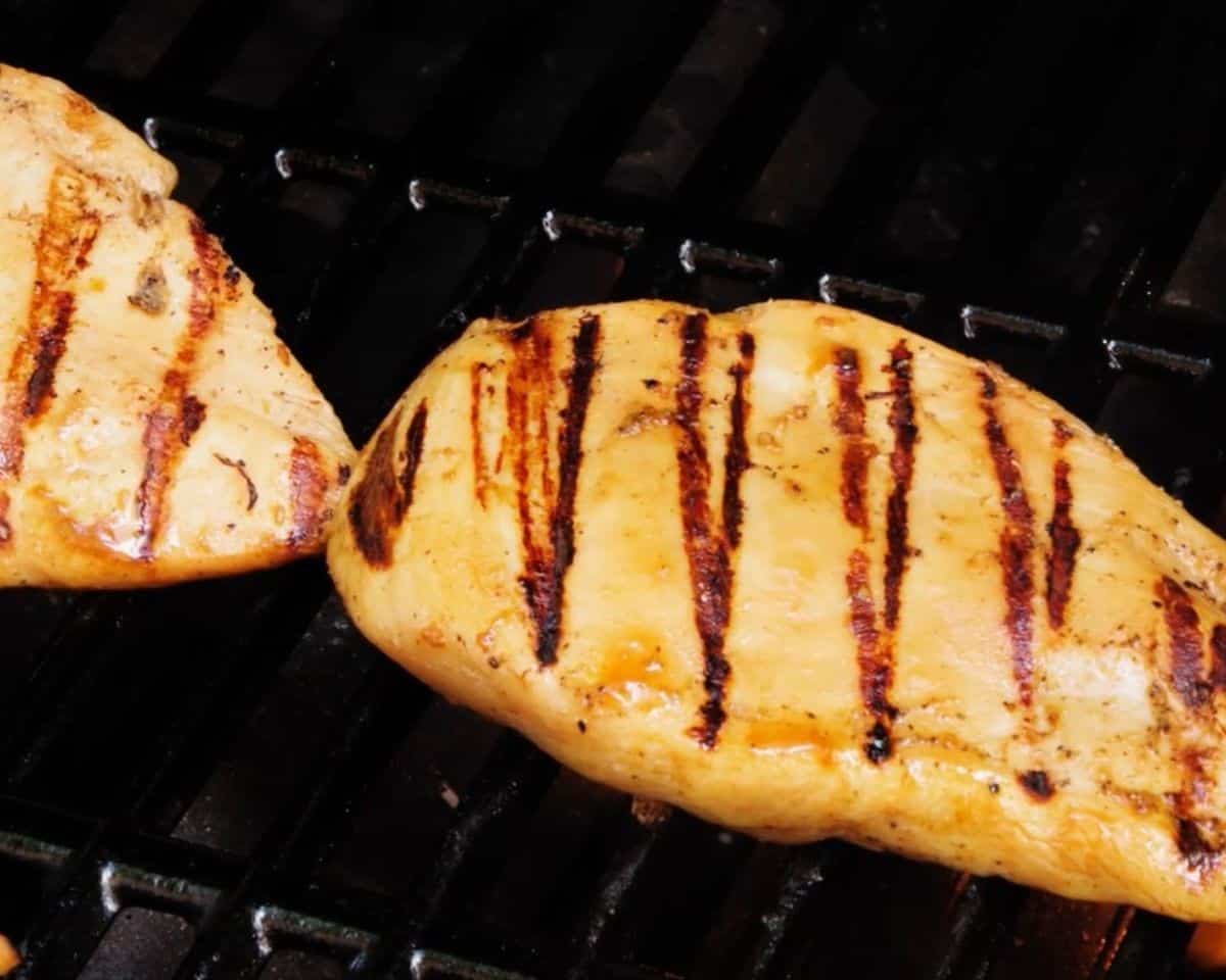 Grilling chicken over a flame.