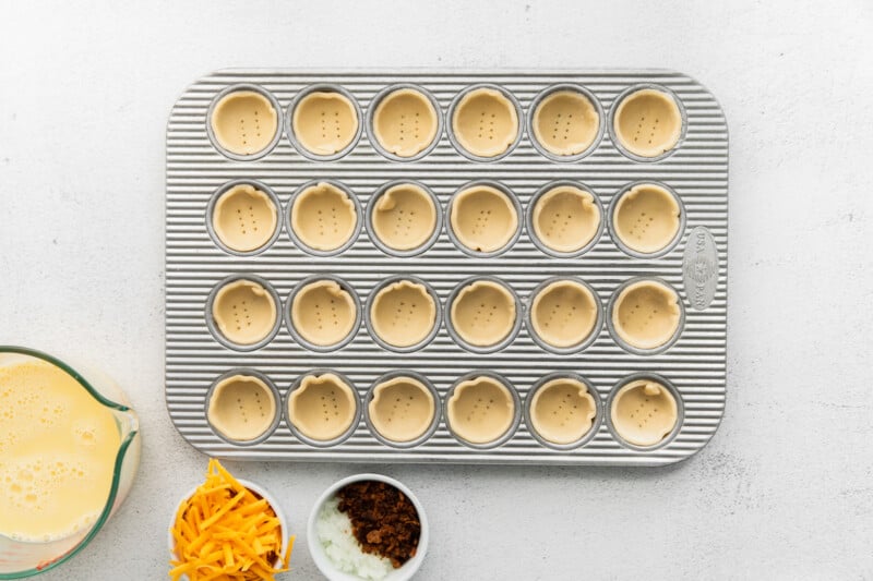 mini quiche crusts in a mini muffin tin.