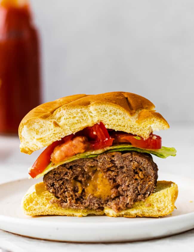 up close half of juicy lucy burger showing cheesy inside