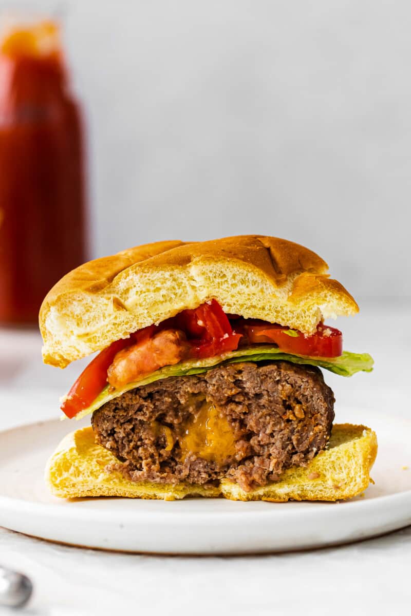 up close half of juicy lucy burger showing cheesy inside