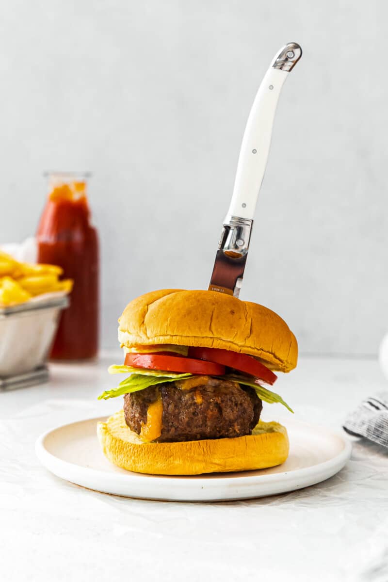knife in air fryer juicy lucy burger on white table