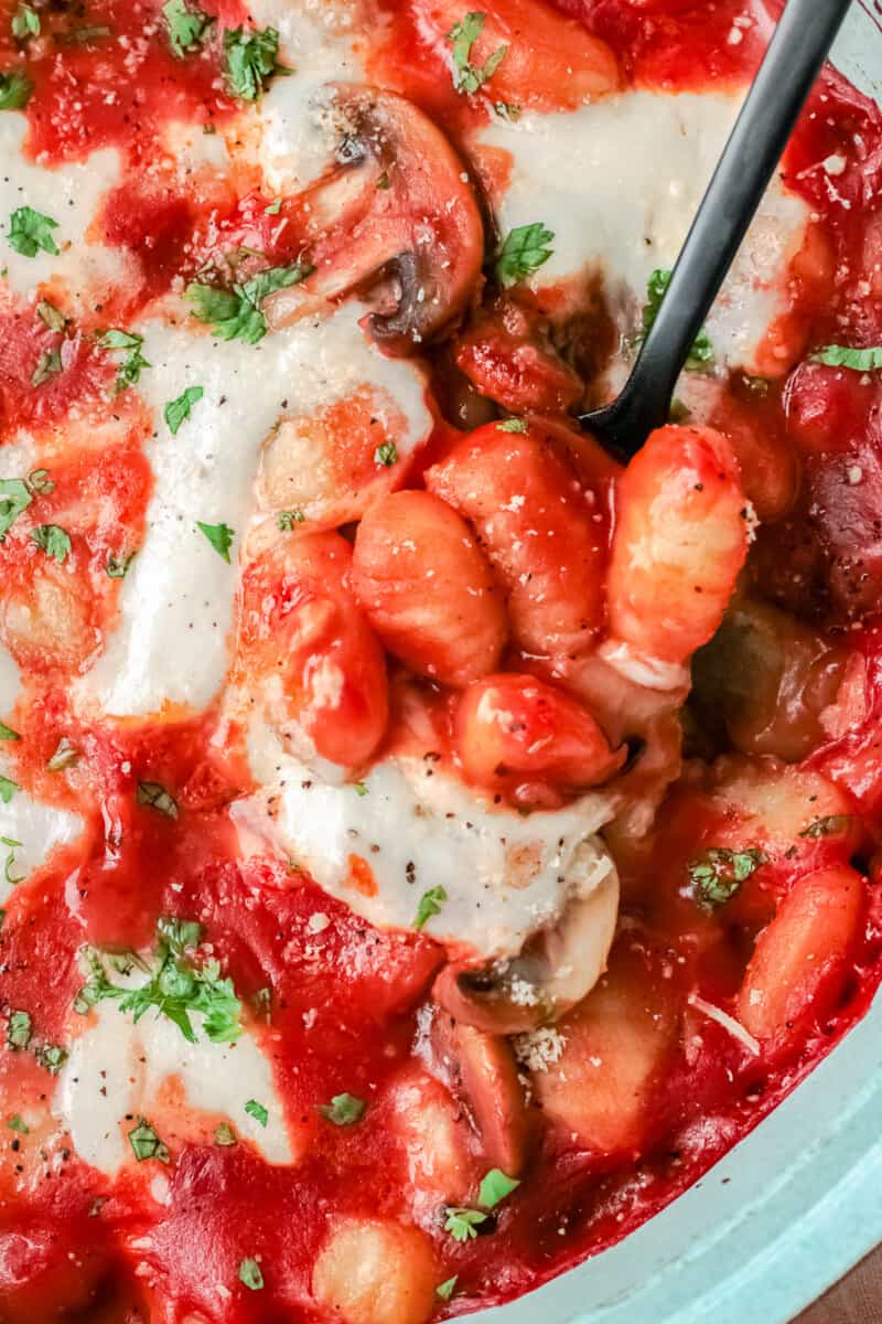 up close cheesy baked gnocchi in baking dish