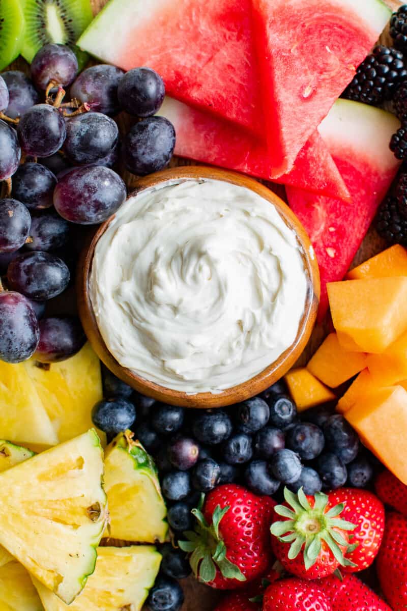 fruit board with cream cheese fruit dip in the middle