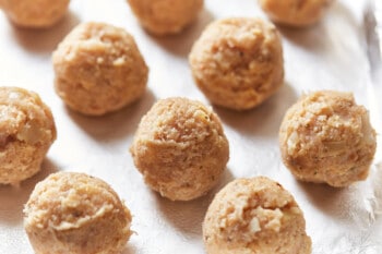 formed raw turkey meatballs on a baking sheet.