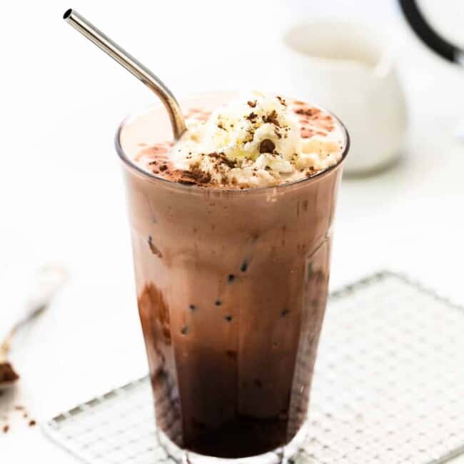 iced mocha in tall glass with whipped cream
