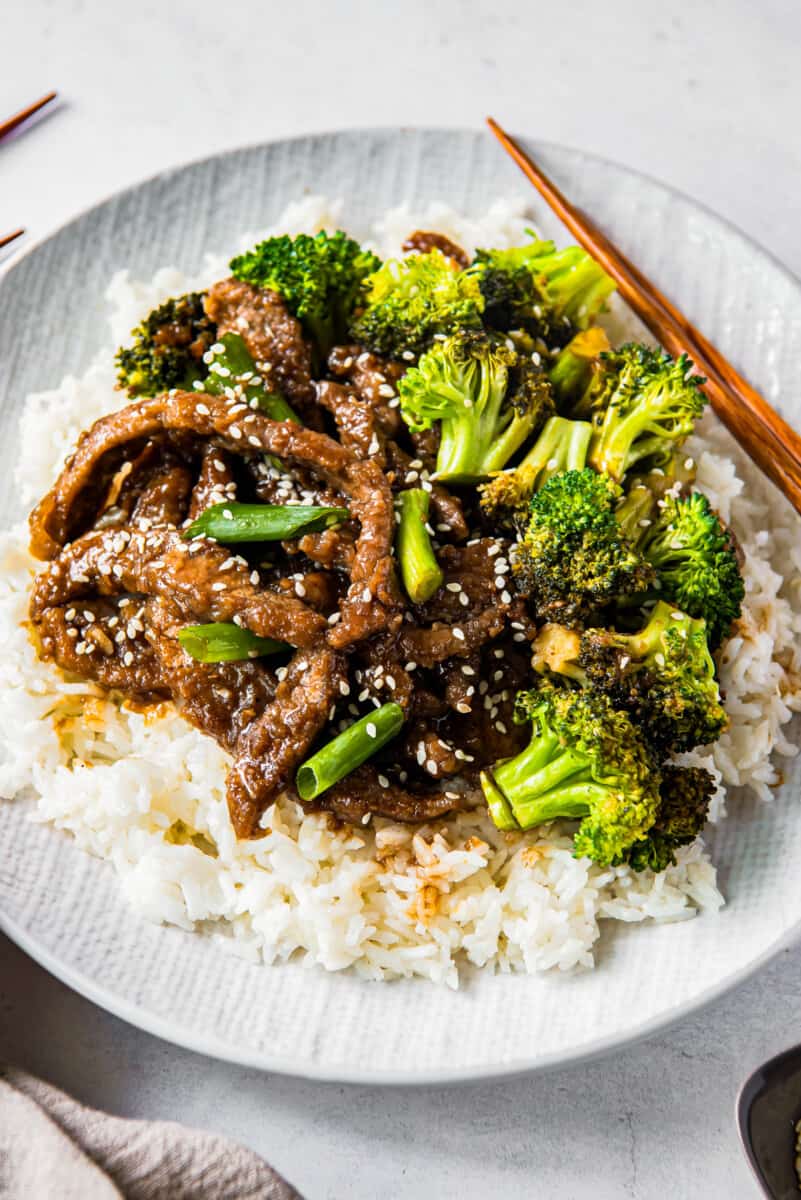 up close Mongolian beef and broccoli on white plate with rice