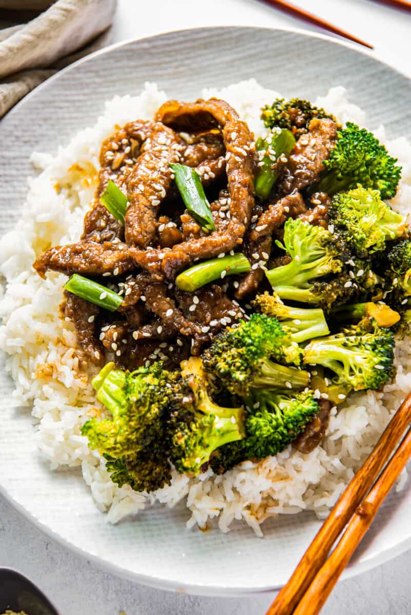 Mongolian beef and broccoli on white plate with rice