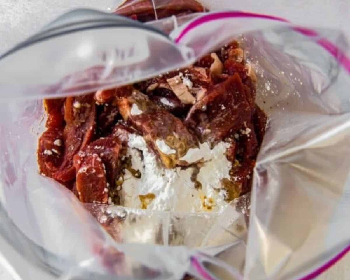 Beef in a Ziplock bag with the marinade ingredients.