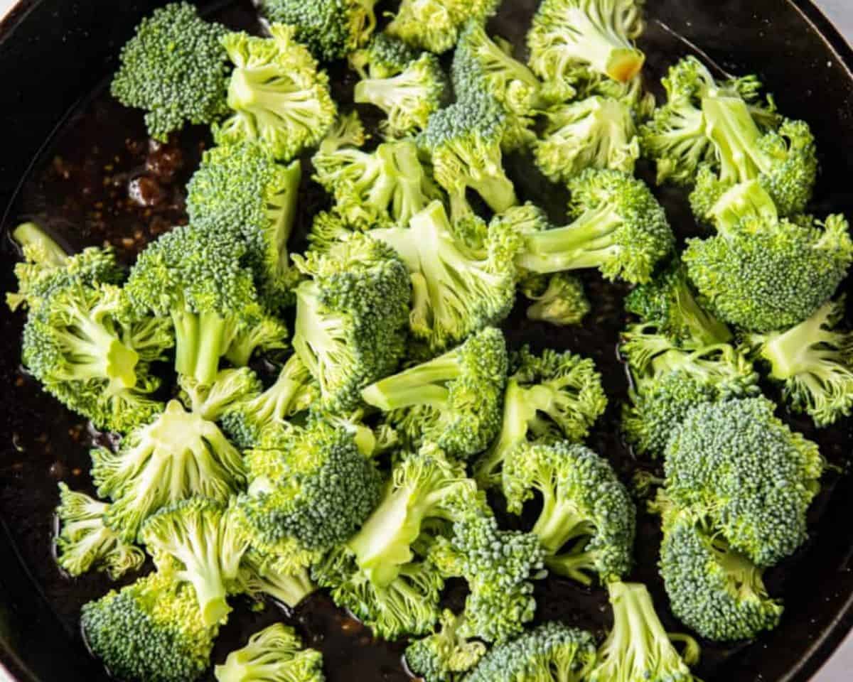 Broccoli added to the pan with the sauce.
