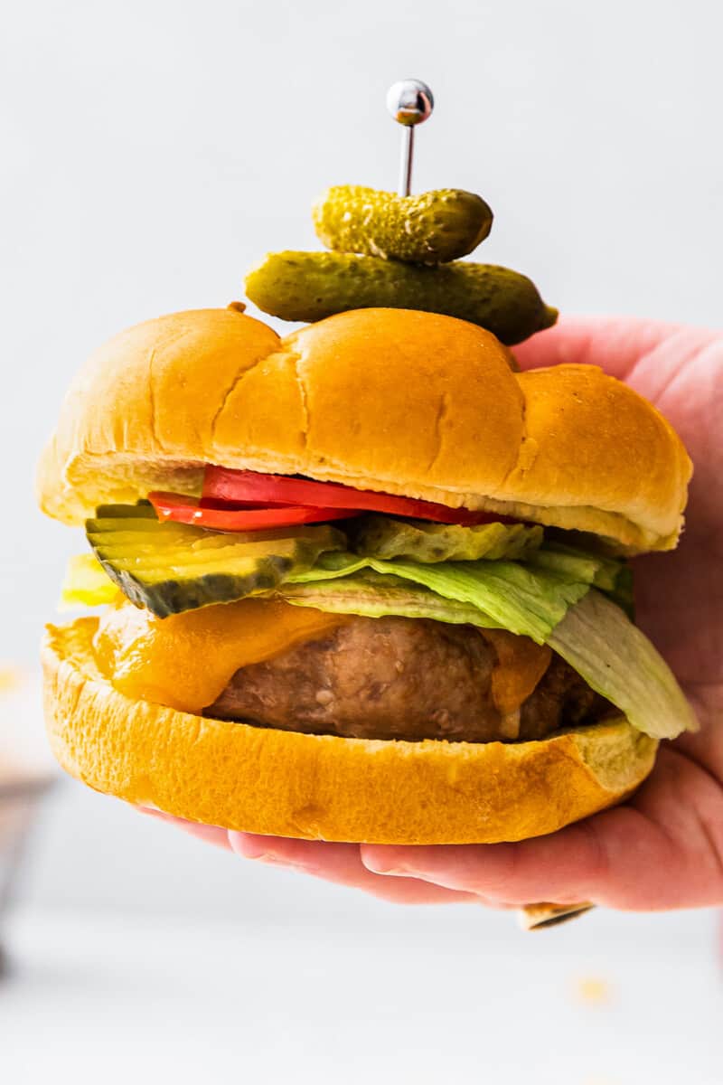 up close holding up air fryer turkey burger