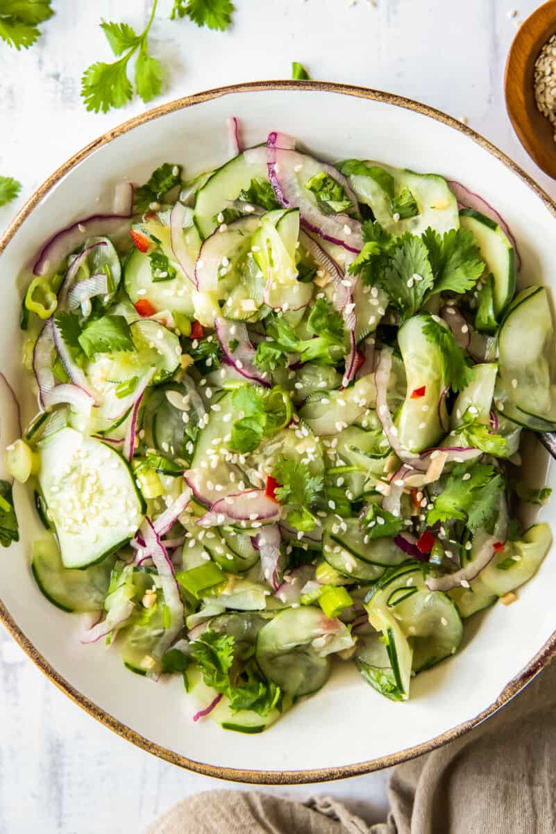 asian cucumber salad in white bowl