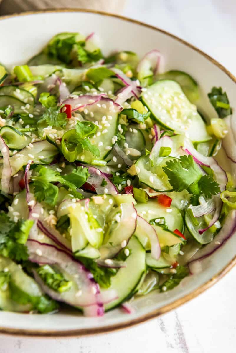 asian cucumber salad in white bowl