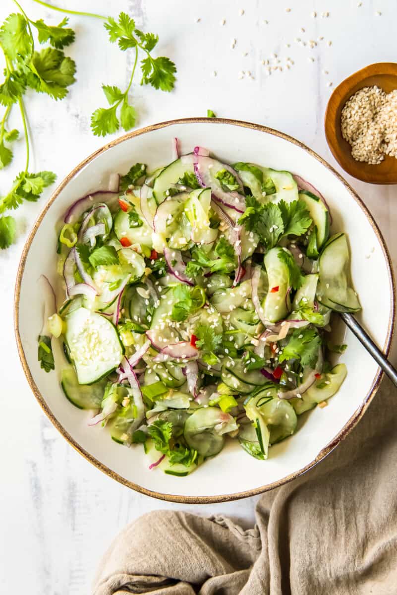 overhead asian cucumber salad in white bowl