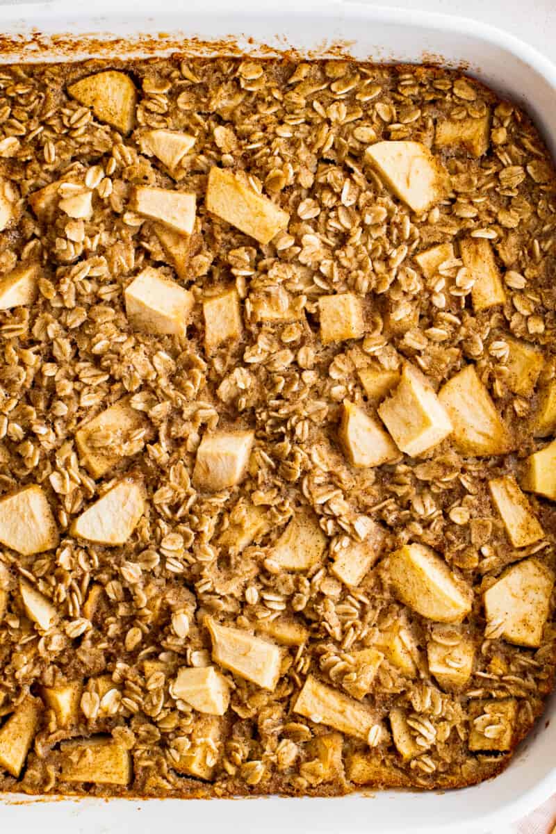 up close slice of baked apple oatmeal on white plate