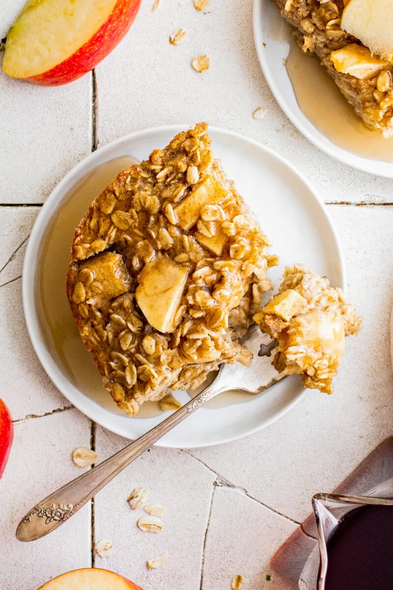 up close slice of baked apple oatmeal on white plate