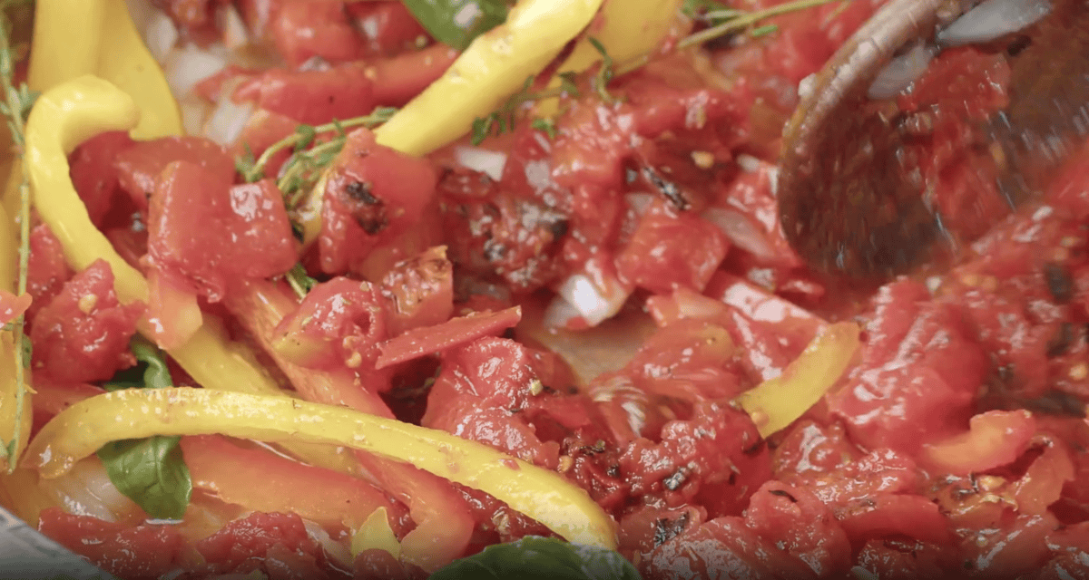 tomatoes and peppers in a pan.