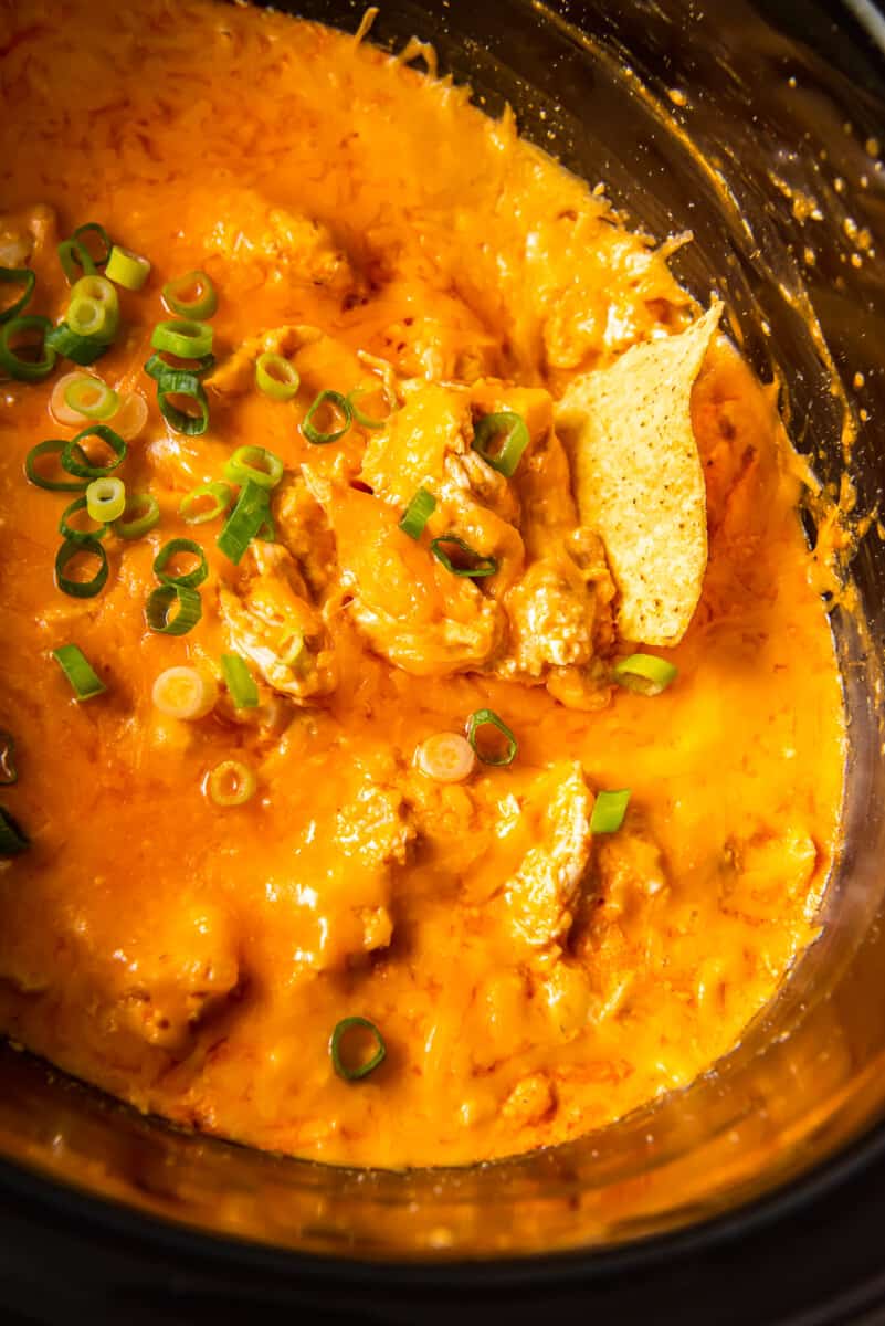 chip in crockpot buffalo chicken dip inside slow cooker
