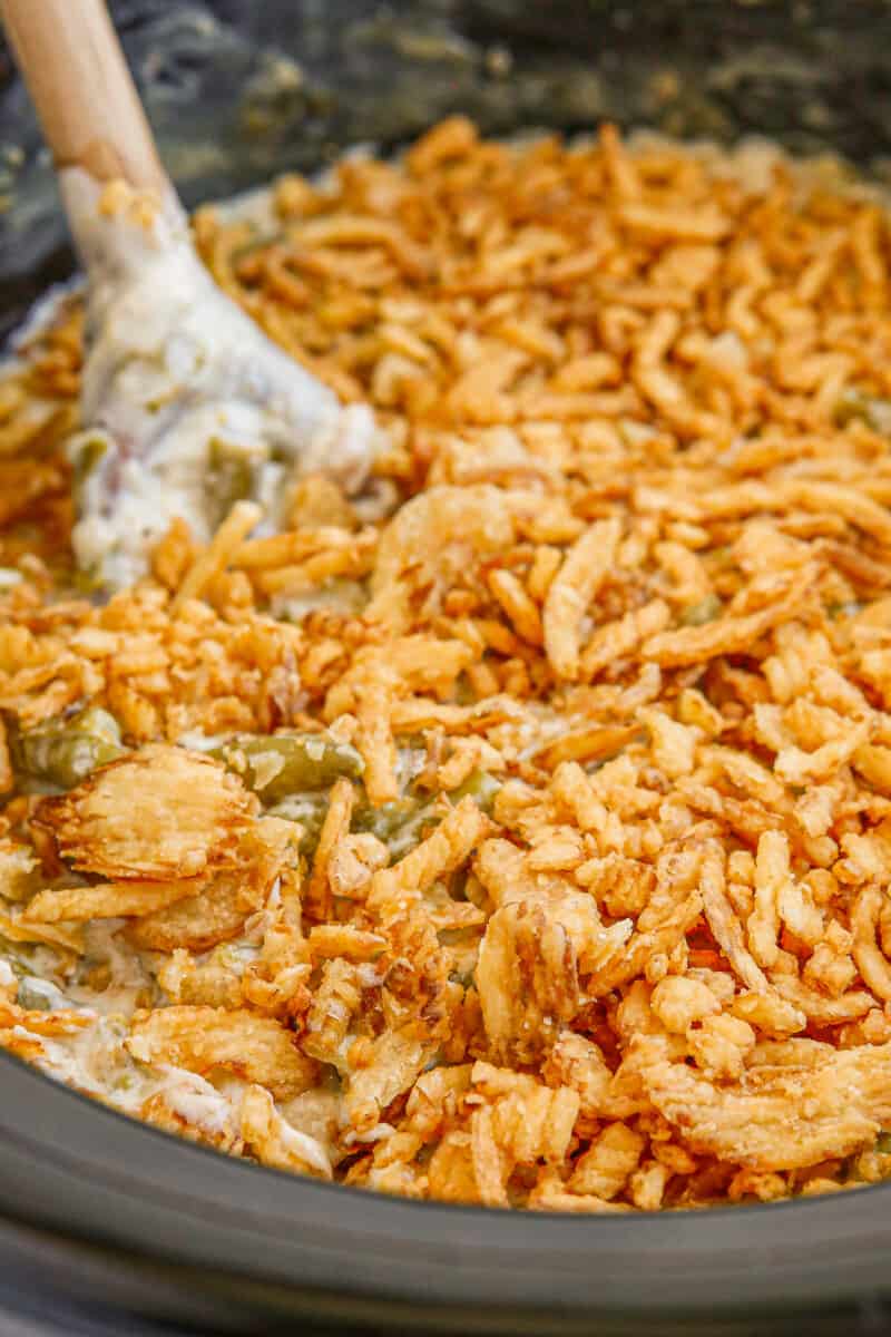 wooden spoon in crockpot green bean casserole