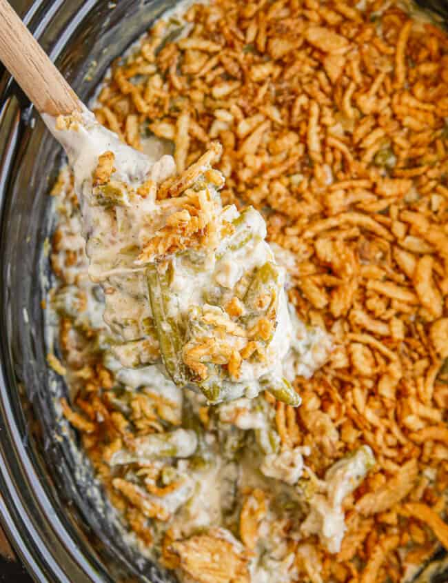 overhead wooden spoon in crockpot green bean casserole