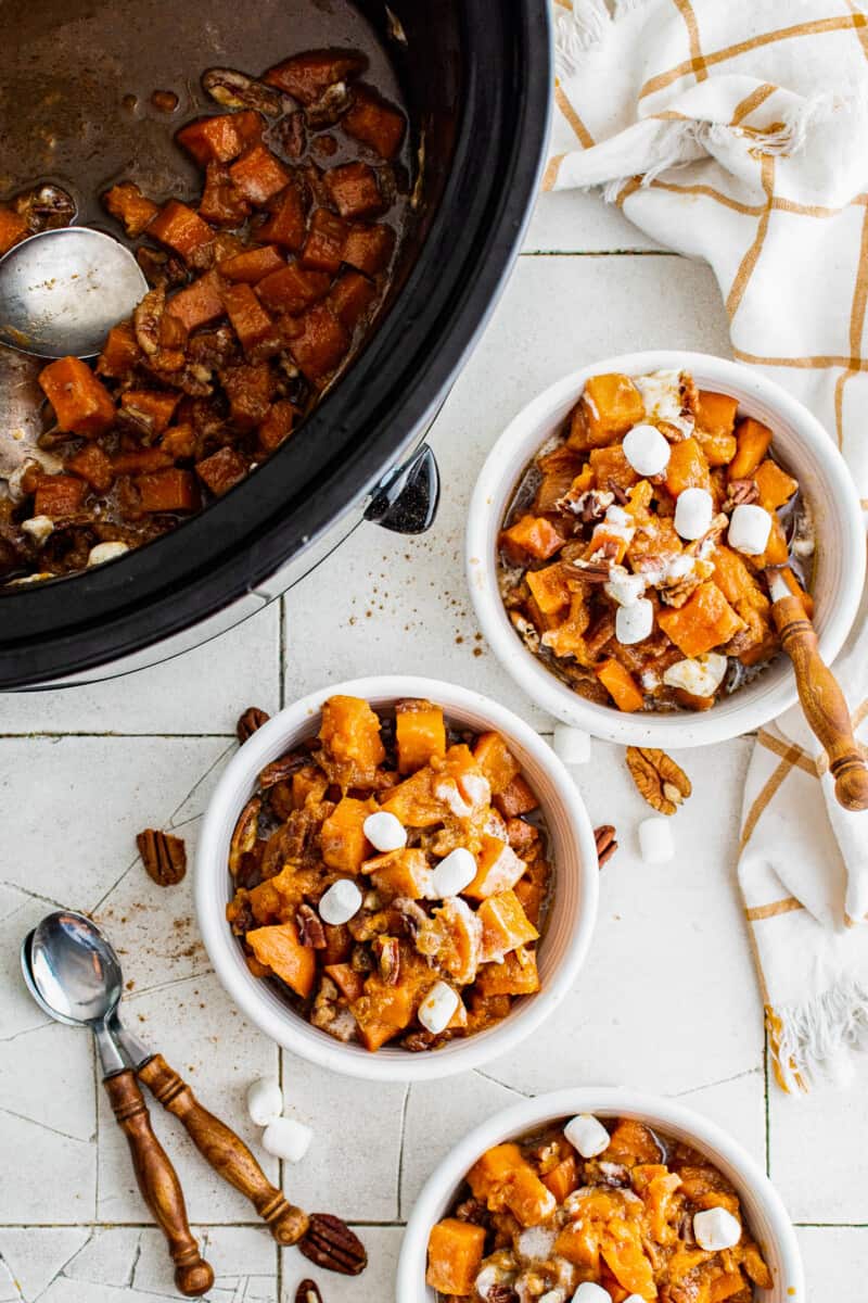 three white bowls with crockpot sweet potato casserole