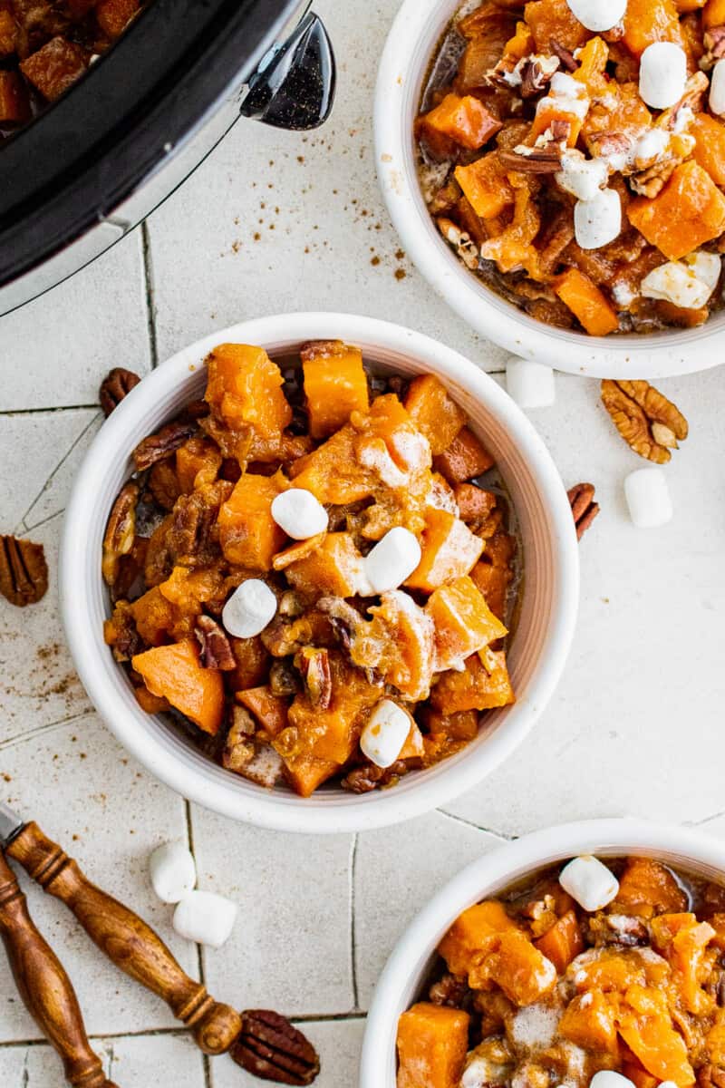 three white bowls with crockpot sweet potato casserole