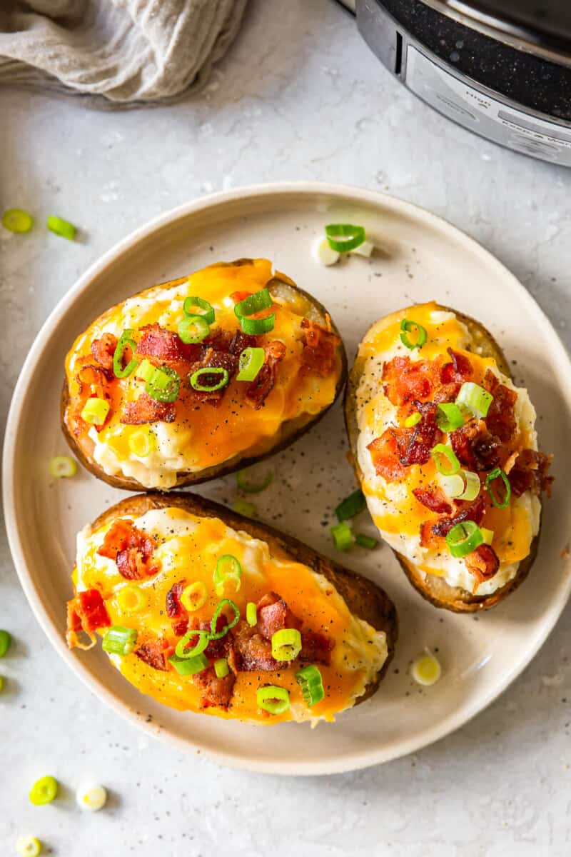 overhead three crockpot twice baked potatoes on white plate