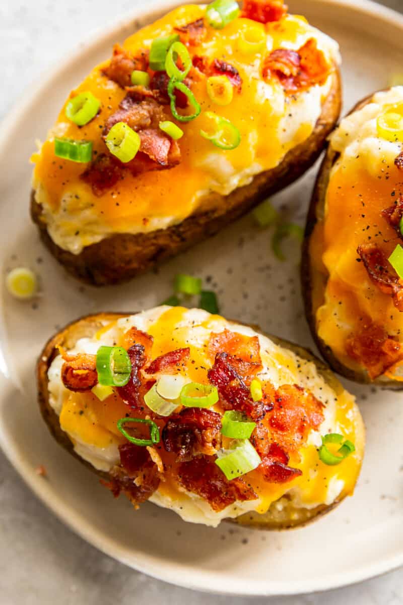 overhead up close three crockpot twice baked potatoes on white plate