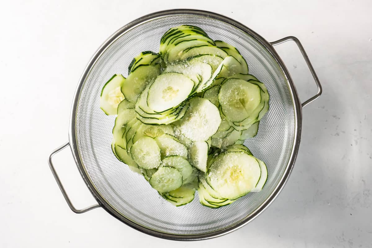 Salted cucumbers in a colander. 