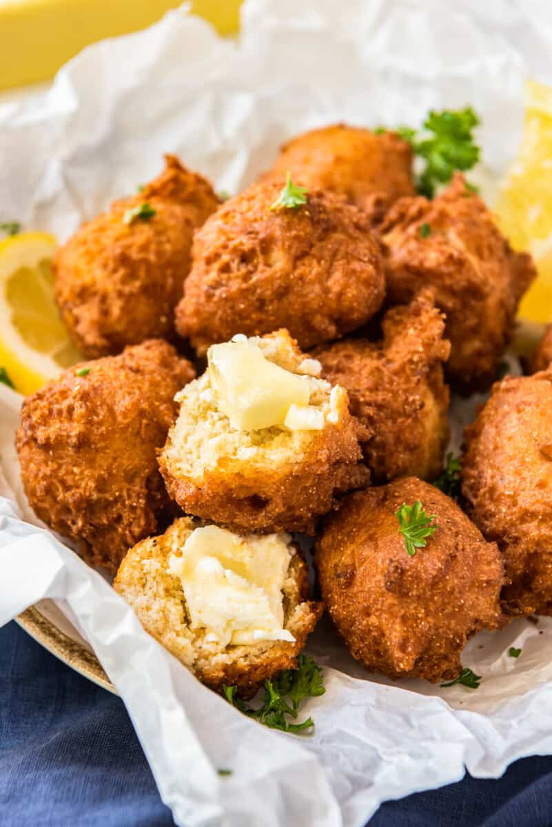 fried hush puppies in basket with butter