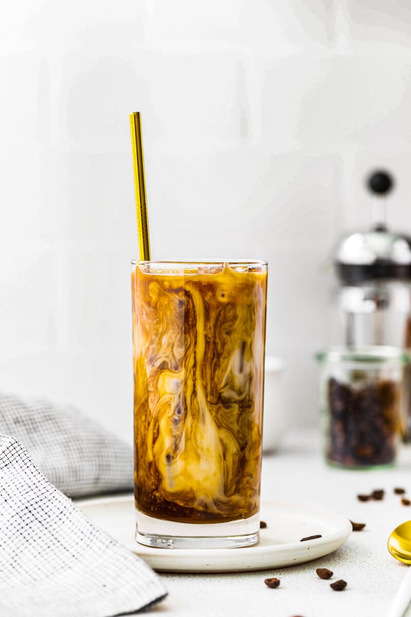 iced caramel latte in tall clear glass with straw
